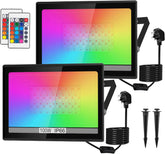 Two RGB LED flood lights with remote controls and power cables on a white background